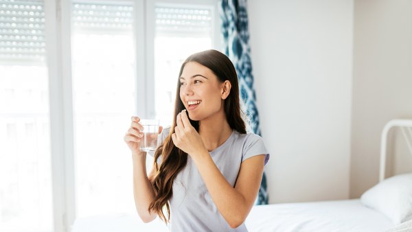 Healthy young woman taking supplements