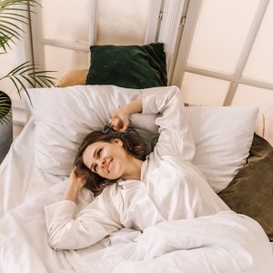 Young beautiful, woman waking up fully rested.