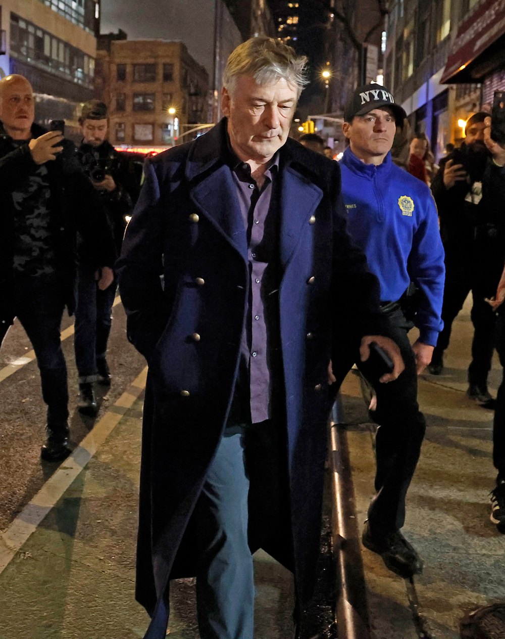 Alec Baldwin is escorted away from a pro-Palestine protest by NYPD officers