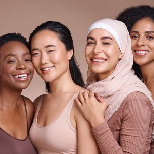 Diversity, women and beauty with skincare and portrait, smile and happy models, different and empowerment with motivation against studio background. Inclusion, equal and gender with culture and skin.