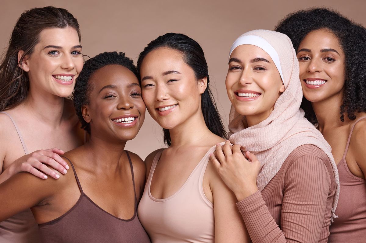 Diversity, women and beauty with skincare and portrait, smile and happy models, different and empowerment with motivation against studio background. Inclusion, equal and gender with culture and skin.
