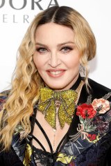Madonna Smiling at Camera wearing Gold Sparkly Bow Necklace
