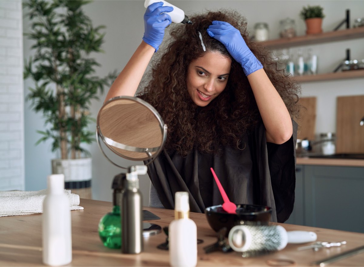 Woman dying her hair at home