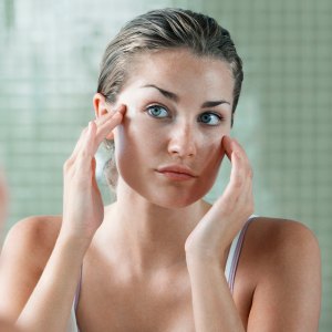 Woman Applying Facial Cream