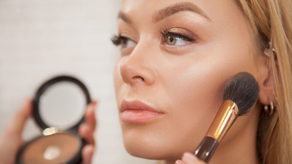 Close up of a beautiful woman getting glammed by professional makeup artist
