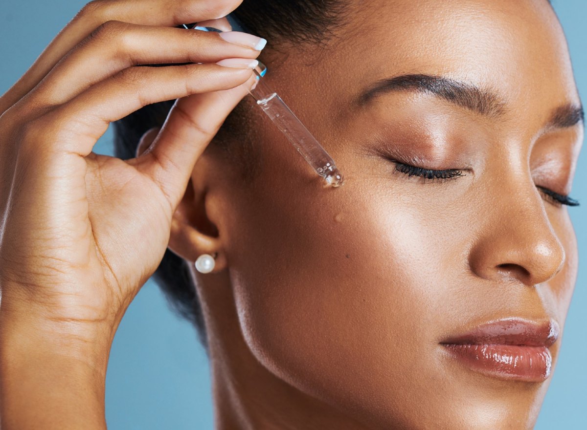 Woman applying face serum