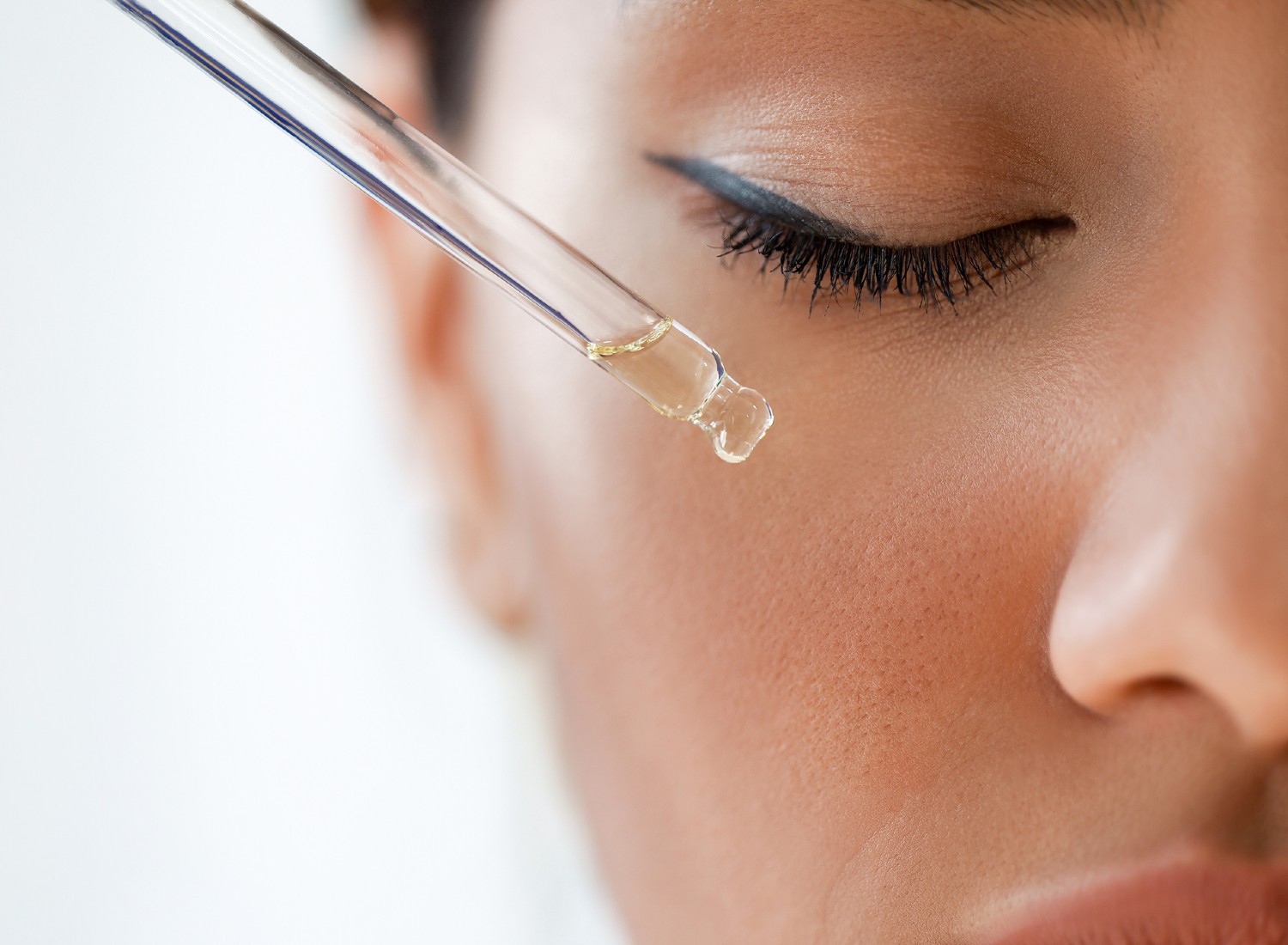 Woman applying face serum