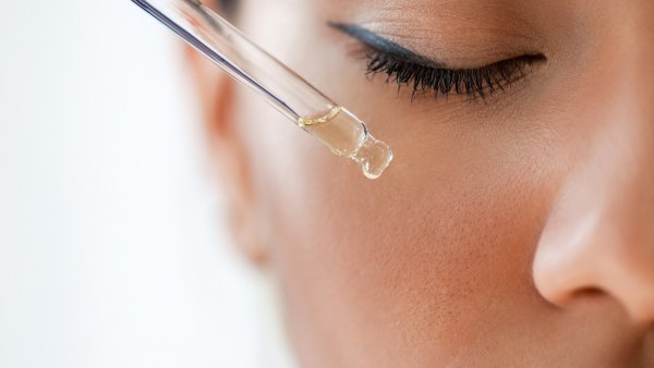 Woman applying face serum