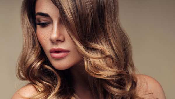 Young beautiful model with long wavy well groomed hair