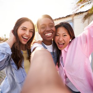 Three women taking selfie