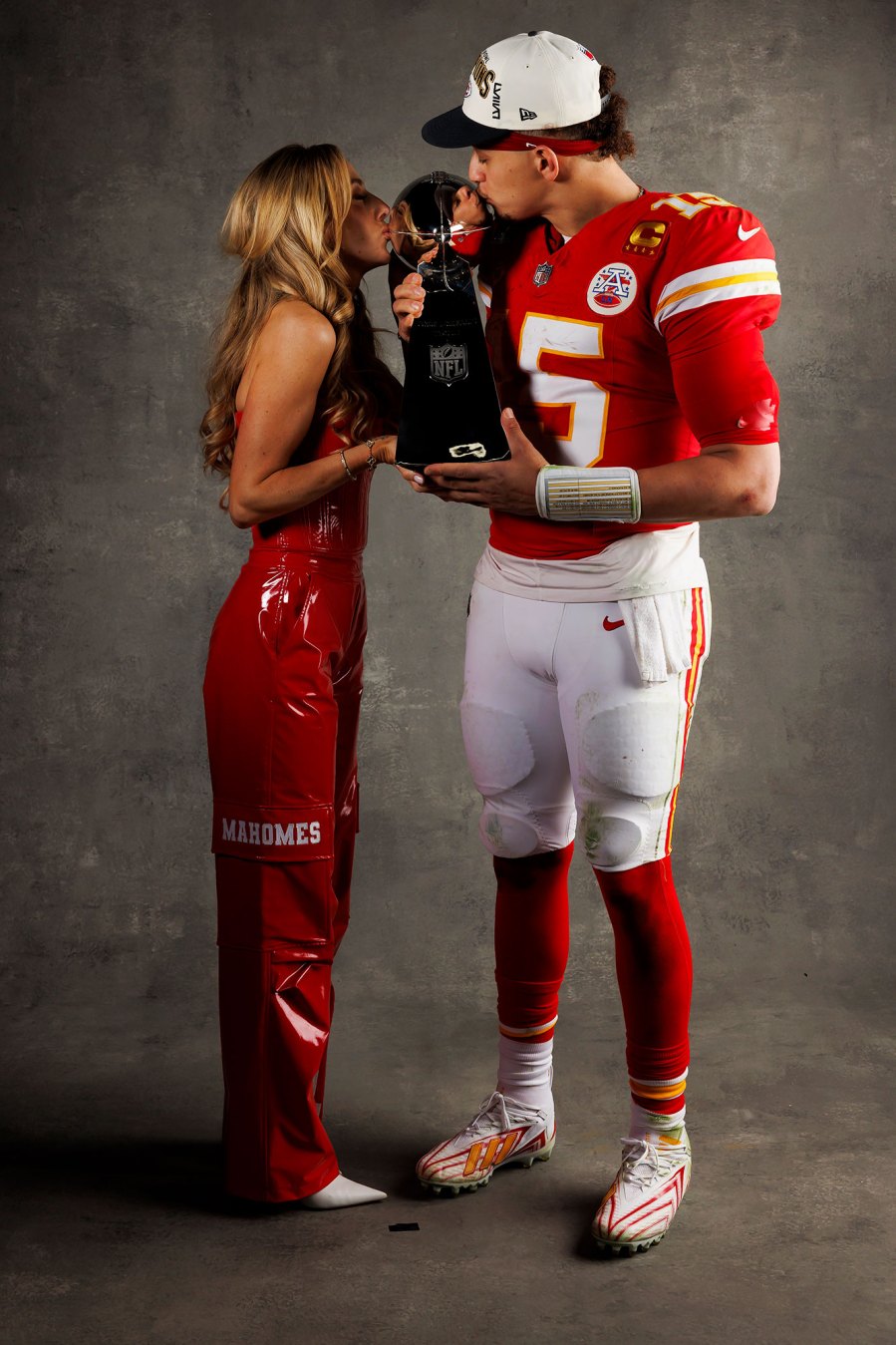 Patrick Mahomes and Brittany Mahomes Kansas City Chiefs Players Kiss Vince Lombardi Trophy in Super Bowl LVIII Winners Portraits