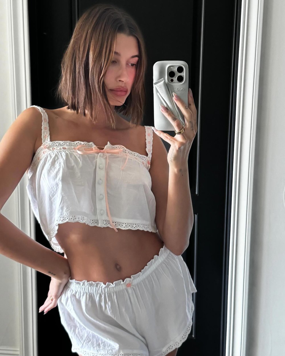 Hailey Bieber Made Us Realize We Need a Phone Case Equipped With a Lip Gloss Holder
