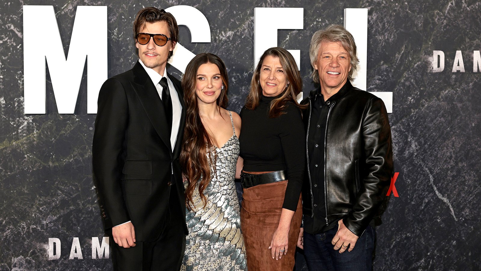 Millie Bobby Brown and Fiance Jake Bongiovi Pose with Jon Bon Jovi on ‘Damsel’ Red Carpet