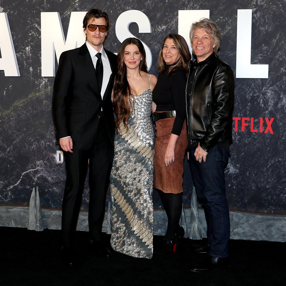 Millie Bobby Brown and fiance Jake Bongiovi pose with Jon Bon Jovi on the 'Damsel' red carpet