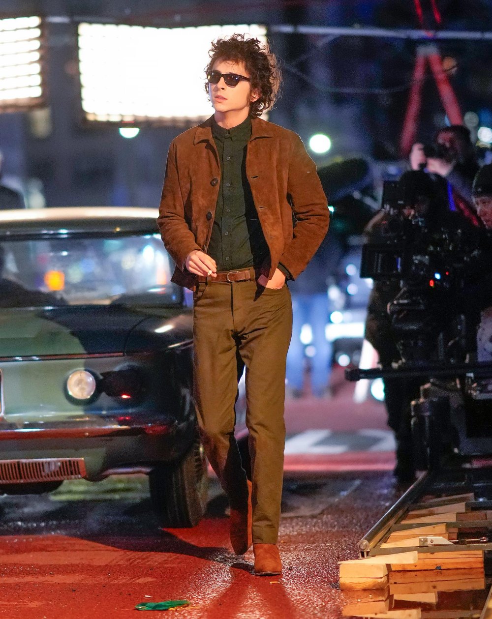 Timothee Chalamet Transforms Into Bob Dylan In Iconic Brown Suede Jacket and Sunglasses