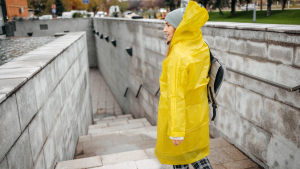 Woman in rain coat in city