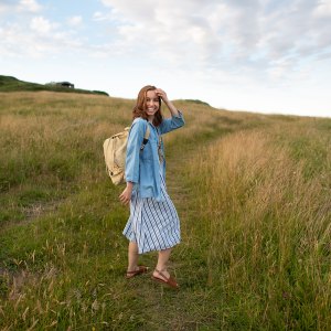 a young woman traveling outdoors carrying a bag in the area de Cantabria in Northern Spain.