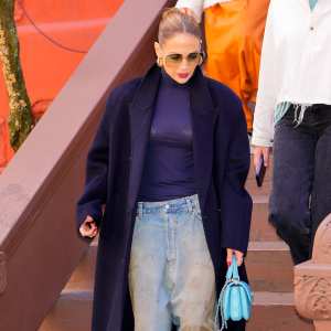 Feature Jennifer Lopez Elevates Faded Baggy Jeans With a Fitted Turtleneck and Sleek Up-Do