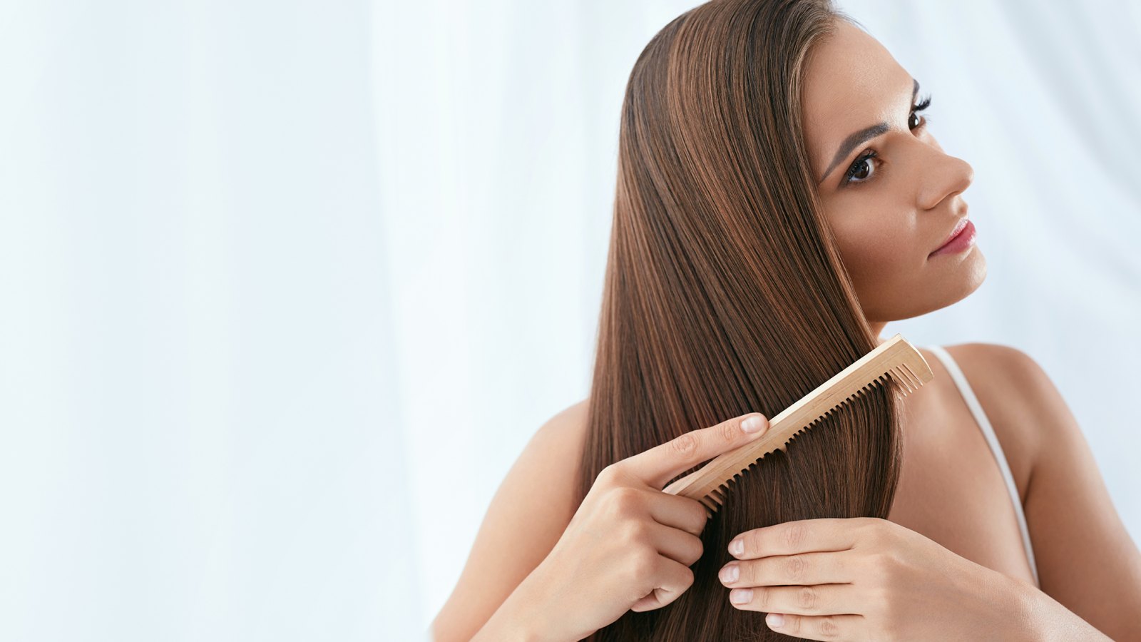 Hair Care. Woman Combing Beautiful Healthy Long Hair With Wooden Brush. High Resolution