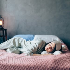 Portrait of woman resting in cozy bedroom.