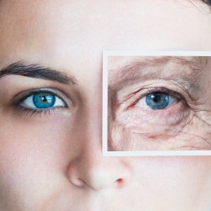 Young woman with photo of aged eye over her own
