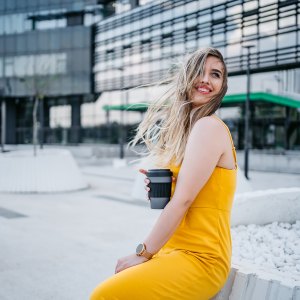 Beautiful young woman drinking coffee in a downtown district.