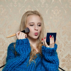 Woman applying makeup
