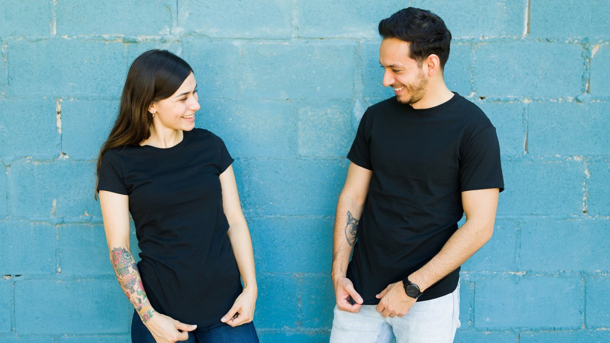 Matching t shirts. Young couple feeling happy after they had t-shirts made with the same designs