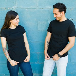 Matching t shirts. Young couple feeling happy after they had t-shirts made with the same designs