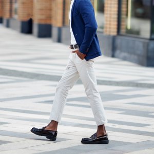Man walks down the street in loafers.