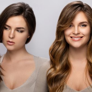 Result of makeover. Young woman happy with her beautiful hair after dyeing and styling in a professional salon.