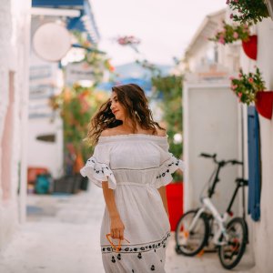Woman Tourist in White Dress in Aegean Seaside Town