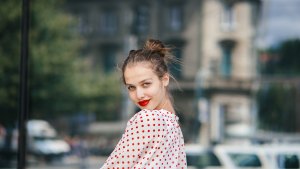Young beautiful woman in the city wearing red lipstick