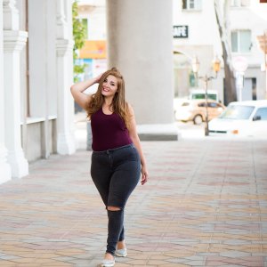 Pretty young woman walking on the city street. Casual fashion, plus size model. xxl women on nature