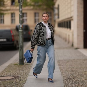 woman wearing jacket, t-shirt and jeans