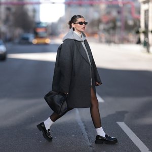 woman wearing coat and loafers
