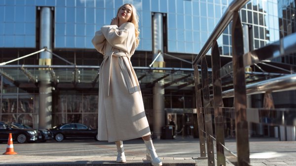 Young blonde woman in autumn city