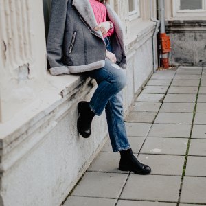 Beautiful young fashionable woman relaxing and enjoying a lovely autumn day in the city street