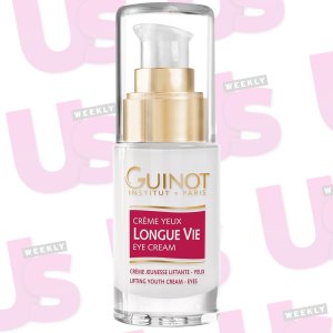 an eye cream in from of wallpaper