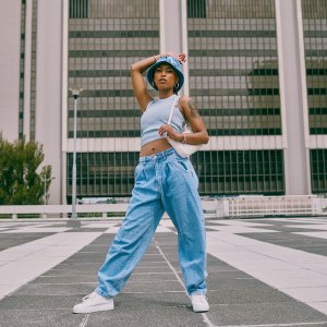 Shot of a trendy young woman posing against a city background