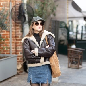 Portrait of a beautiful young fashionable woman wearing a cap.