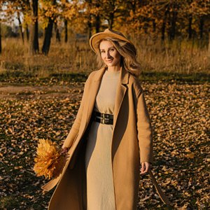 woman in the fall wearing knit dress and coat