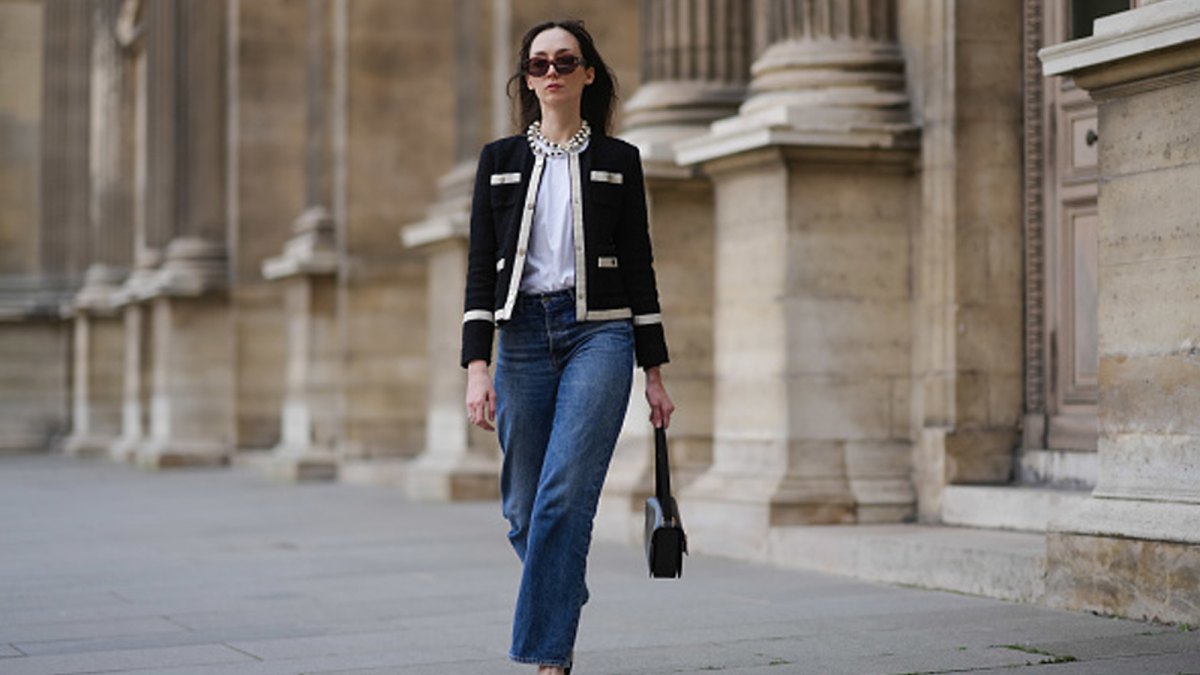woman wearing chic black and white jacket and blue jeans