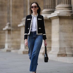 woman wearing chic black and white jacket and blue jeans