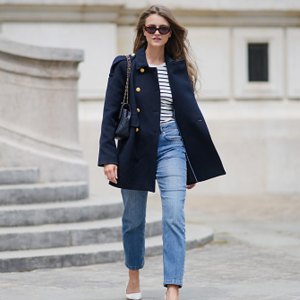 woman in navy blazer and blue jeans