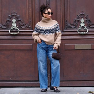 woman wearing fall sweater and jeans