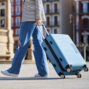 Close-up of a woman with a trolley on the street on the way to the hotel