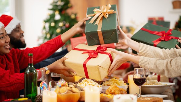 The family is happily exchanging gifts at Christmas.