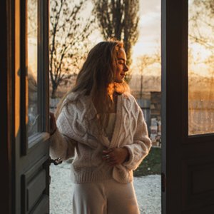 woman wearing beige matching set by door