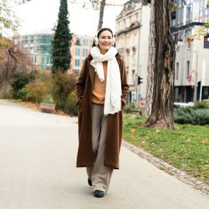 Portrait of a happy Asian woman enjoying music on the move